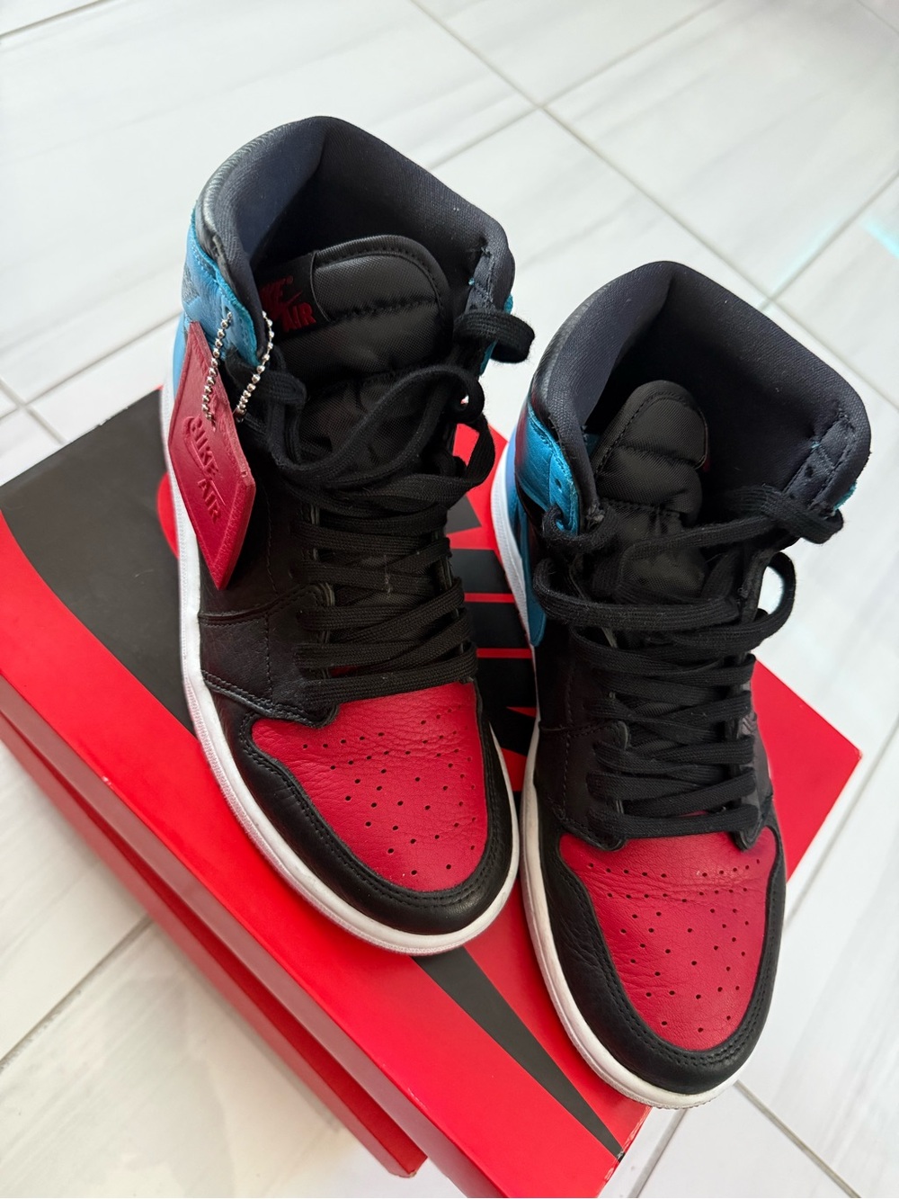 Women Air Jordan 1 High OG Sneakers in Black, Red, and Blue